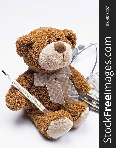 Doctor Teddy Bear with medical thermometer and stethoscope and pills. Doctor Teddy Bear with medical thermometer and stethoscope and pills