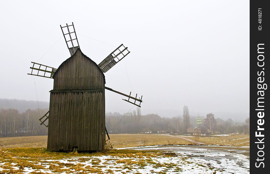 Windmill in ukranian village at winter time. Windmill in ukranian village at winter time