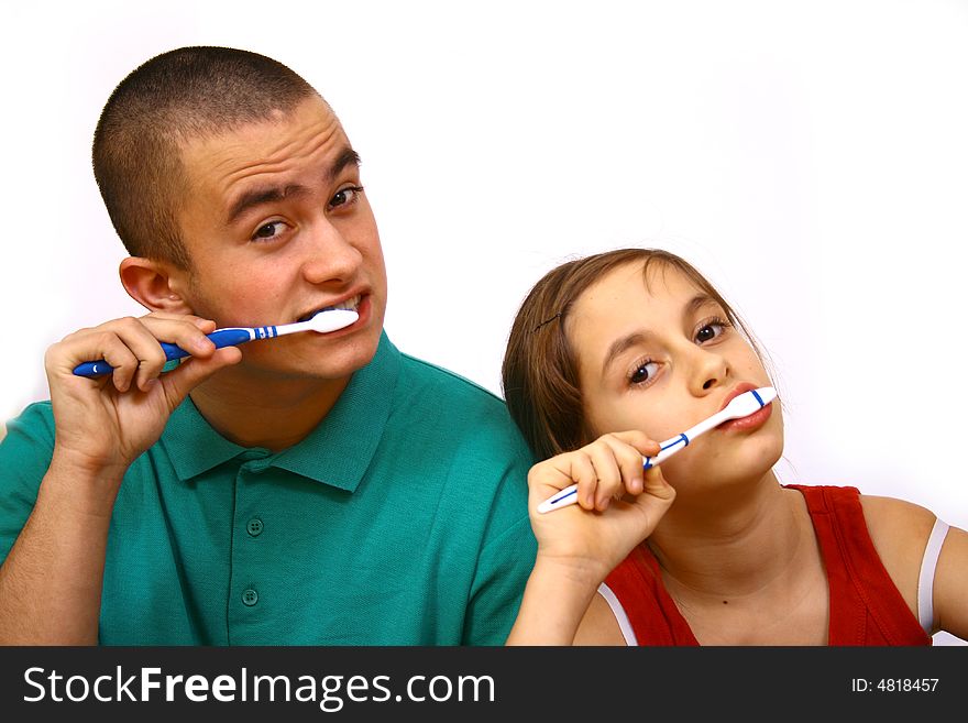 Brother and sister clean a teeth.