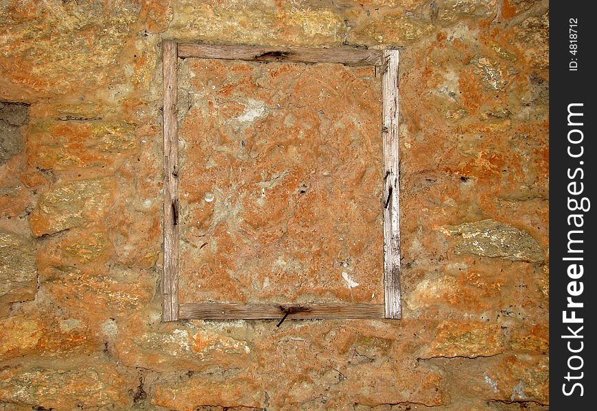 Old wooden frame with nails is in a stone wall. An apartment before repair works. Old wooden frame with nails is in a stone wall. An apartment before repair works.