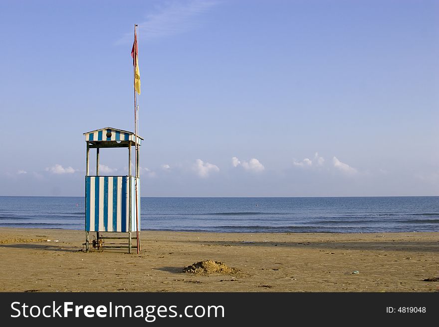 View of an empty beach and lifeguard tower on the Adriatic. View of an empty beach and lifeguard tower on the Adriatic