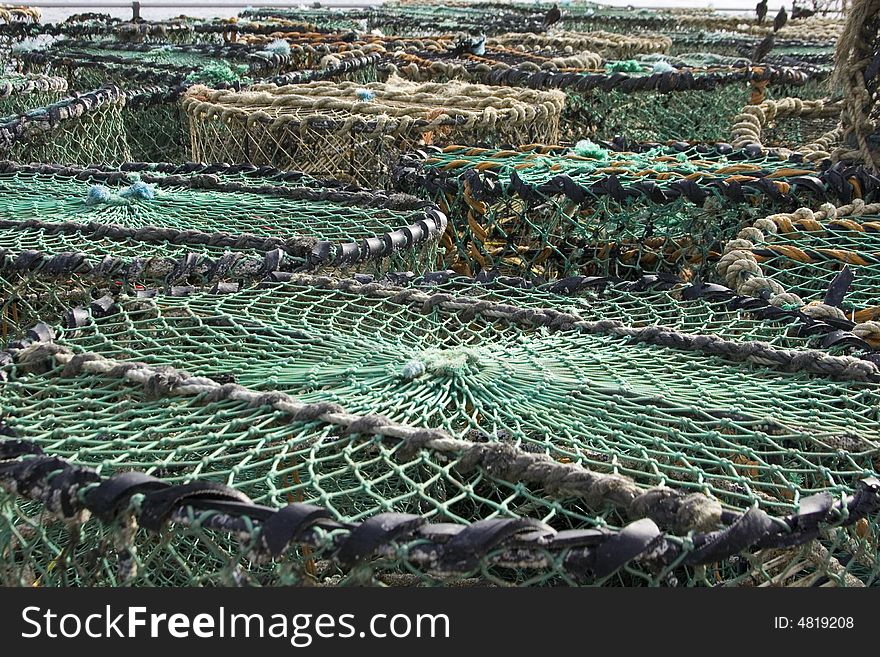 Stacked row of lobster traps on the quayside