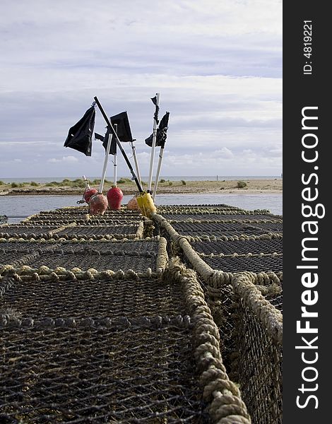 Stacked row of lobster traps on the quayside