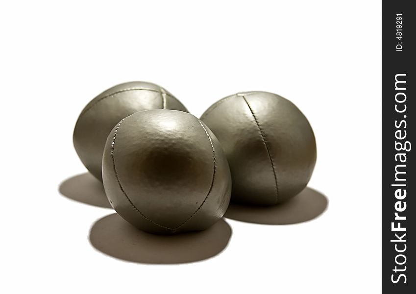 Three silver juggling balls on a white background.