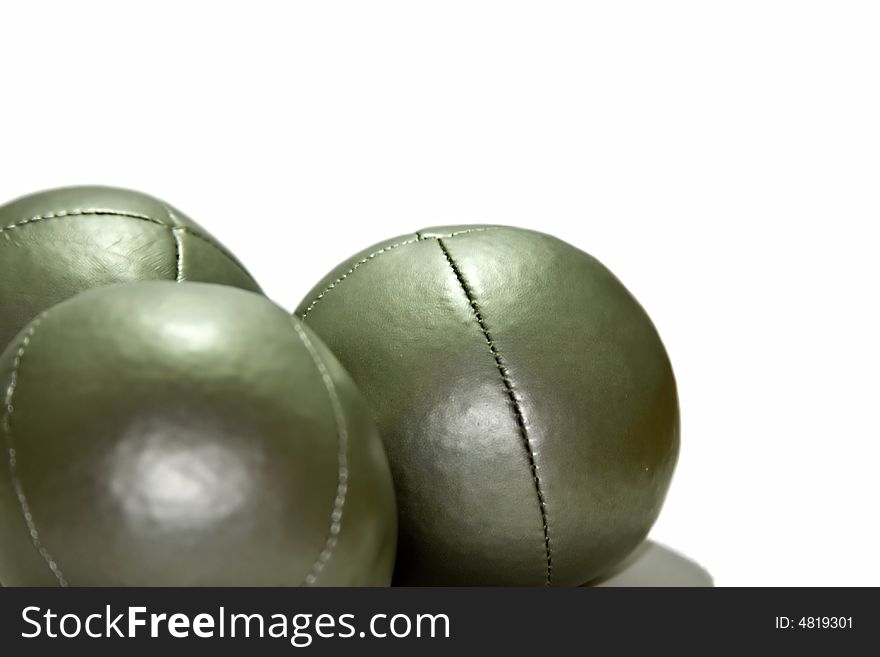 A close up of three juggling balls on a white background.
