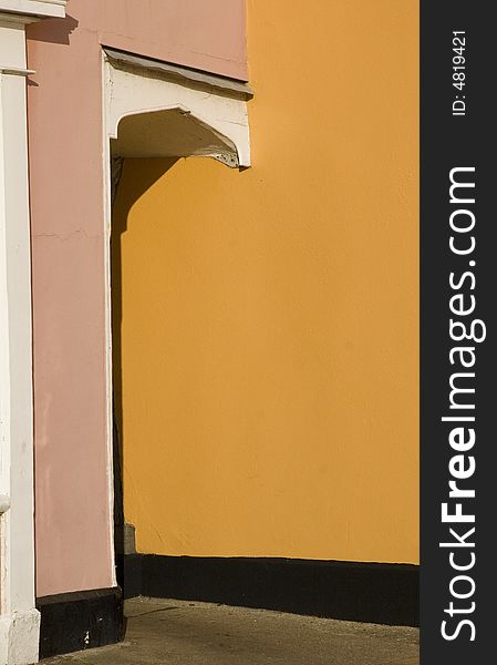 Detail of pink and terracotta entrance to an alleyway. Detail of pink and terracotta entrance to an alleyway