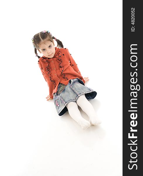The Little Sitting Girl Isolated On A White