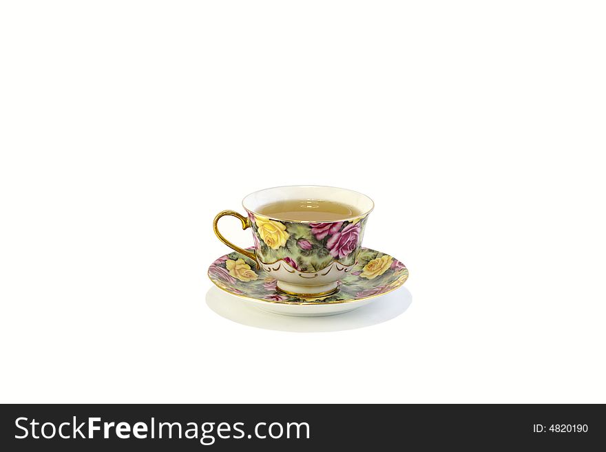 Cup with the green tea stands on the saucer against the white background