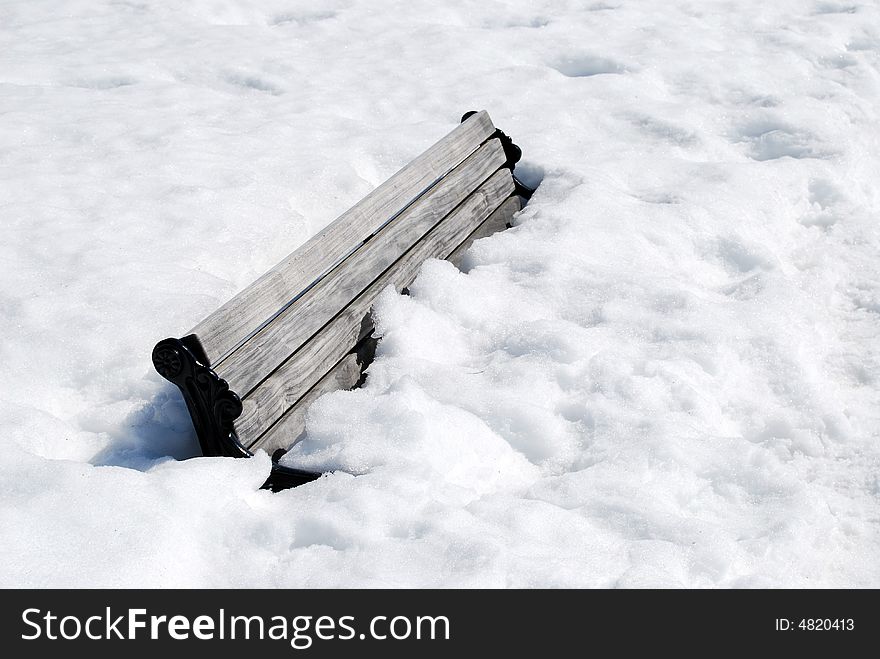 A bench covered of snow