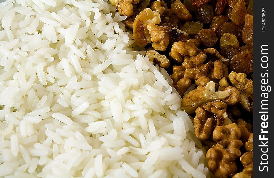 The image contains rice, nuts and raisin. The image contains rice, nuts and raisin