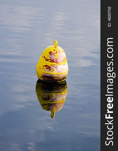 Yellow mooring buoy in the water. Yellow mooring buoy in the water