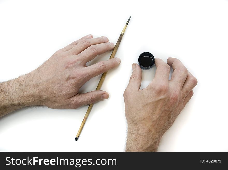 Artist's hands with the brush and ink