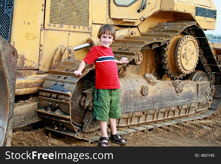 Little Boy in Leaning on a Bulldozer. Little Boy in Leaning on a Bulldozer