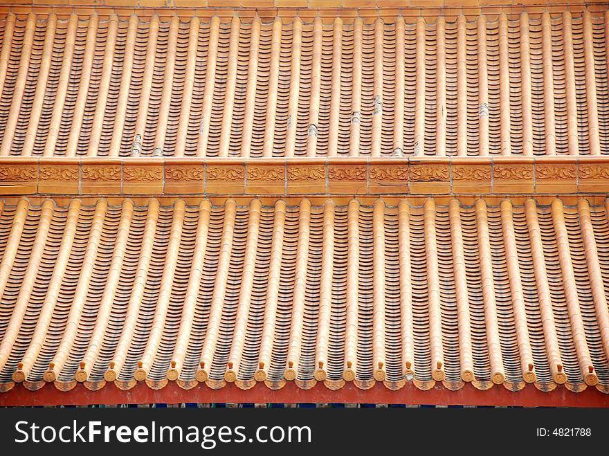 The roofs of a Chinese imperial palace,files of yellow ceramic tiles. The roofs of a Chinese imperial palace,files of yellow ceramic tiles.