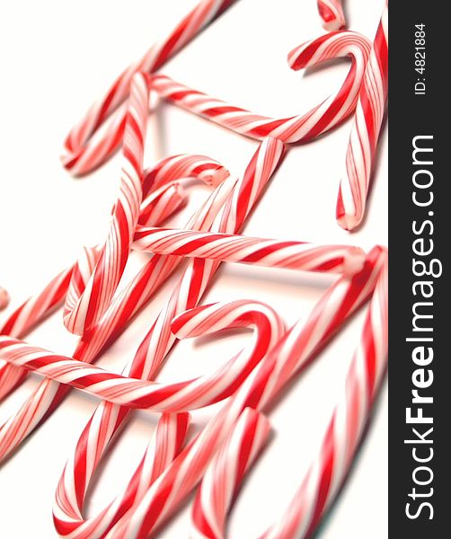 An array of candy canes scattered on a white background. An array of candy canes scattered on a white background