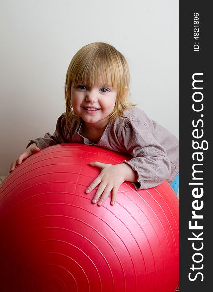 The little girl with a greater red ball. The little girl with a greater red ball