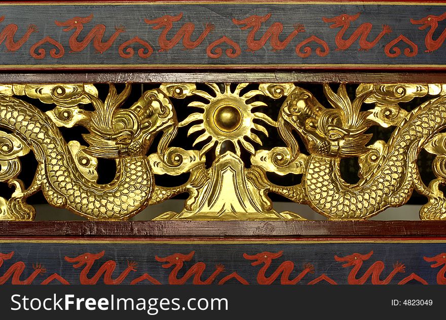 China; shangai; temple decor; traditional design for these wooden carved dragons in gold leaf