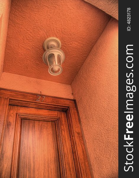 Light fixture over door in stucco entryway