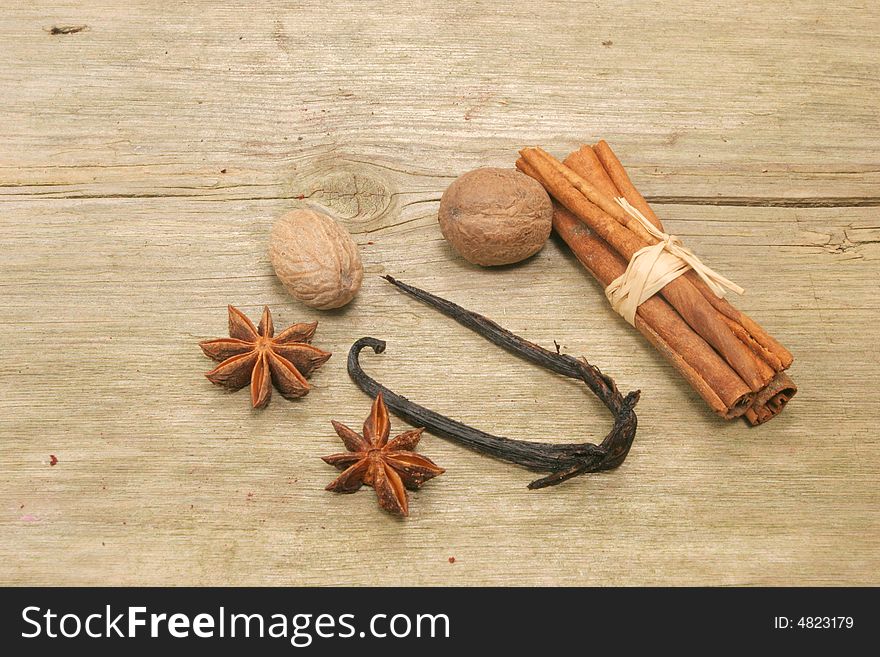Spices,vanilla,nutmeg,cinnamon and star anise on old rustic wood. Spices,vanilla,nutmeg,cinnamon and star anise on old rustic wood
