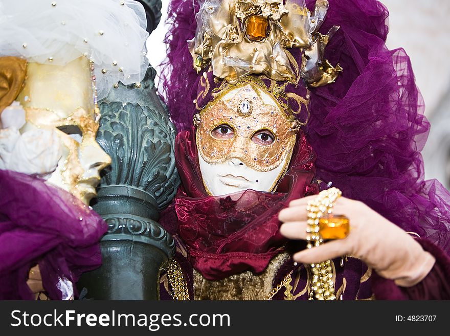 Gold and purple costume at the Venice Carnival. Gold and purple costume at the Venice Carnival