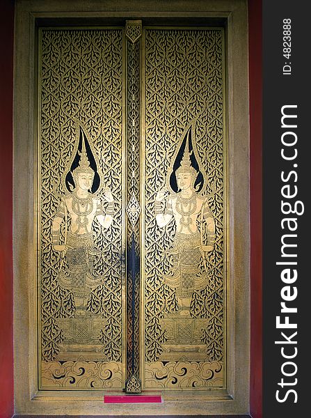 Thailand, Bangkok: door of the golden buddha temple; carved wood decorated with golden leaf. Thailand, Bangkok: door of the golden buddha temple; carved wood decorated with golden leaf