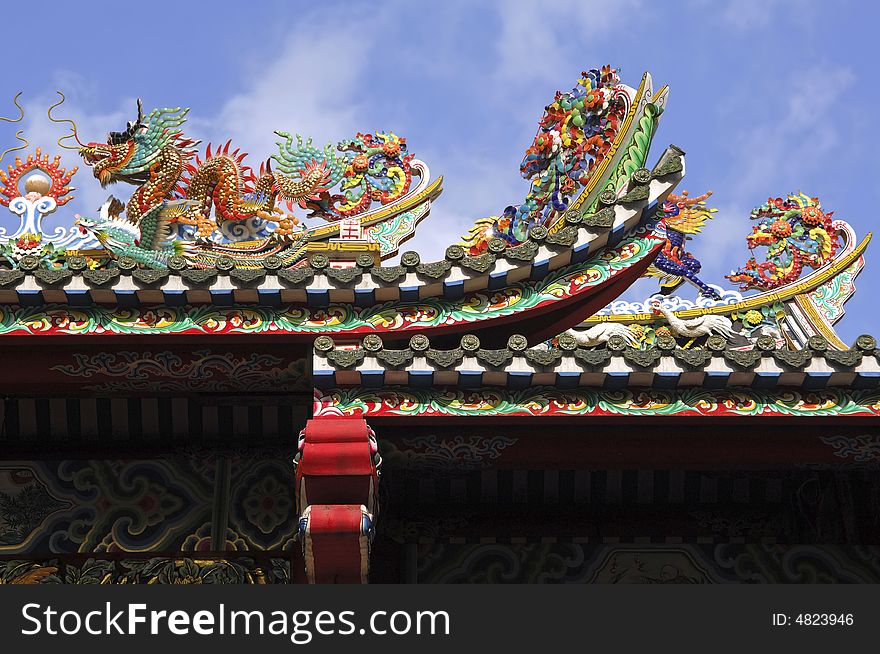 Thailand, Bangkok: Chinatown, temple; detail of the temple's roof with the typical fantastic dragon