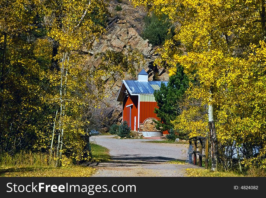 A red country barn in Colorado amongst Golden Autumn trees. A red country barn in Colorado amongst Golden Autumn trees