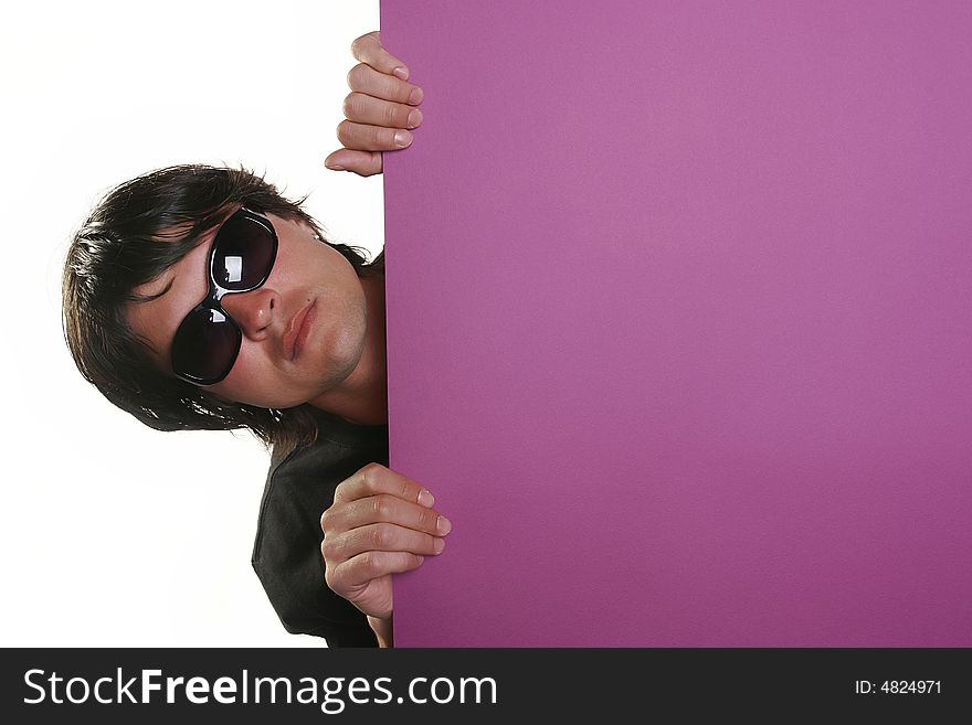 Young man with sunglasses holding a billboard. Young man with sunglasses holding a billboard