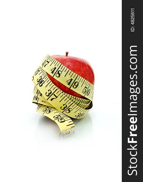Apple wrapped in tape measure. Apple wrapped in tape measure