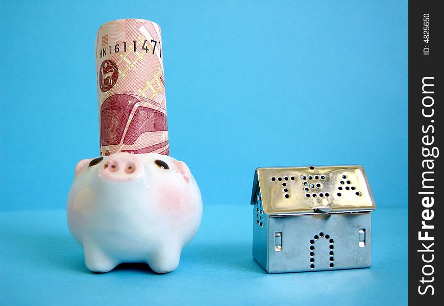 A house beside with money and piggy, metaphors for banking, finance