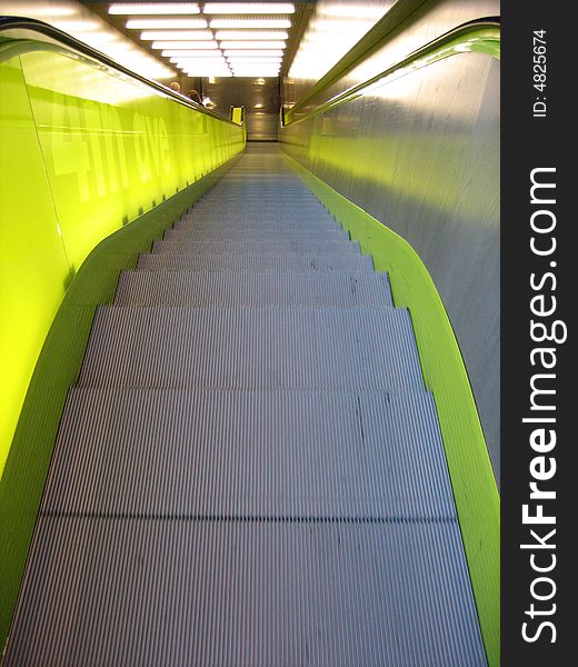 Downward view of green escalator