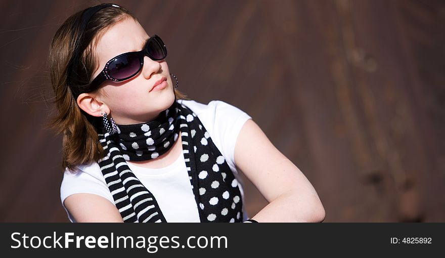 Head and Shoulders portrait of a preteen girl wearing sunglasses. Head and Shoulders portrait of a preteen girl wearing sunglasses.