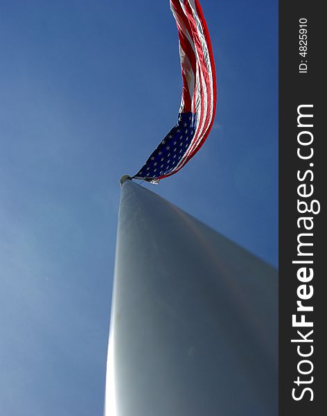 A unique view of a large American flag flying from the top of an aluminim flagpole. A unique view of a large American flag flying from the top of an aluminim flagpole.