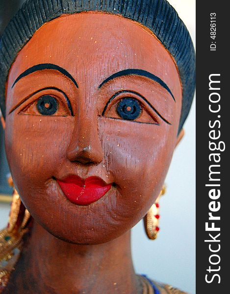 A wooden statue of a woman from Thailand. A wooden statue of a woman from Thailand.