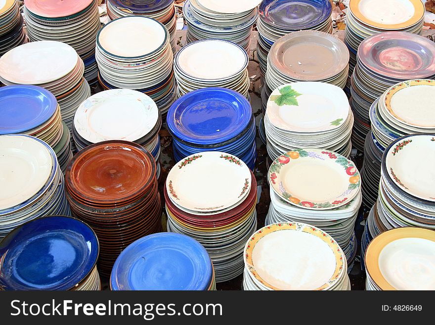 Stacks of colorful plates in different designs