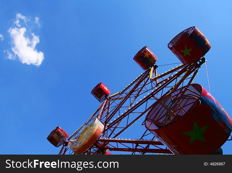 A red ferris wheel against the sky