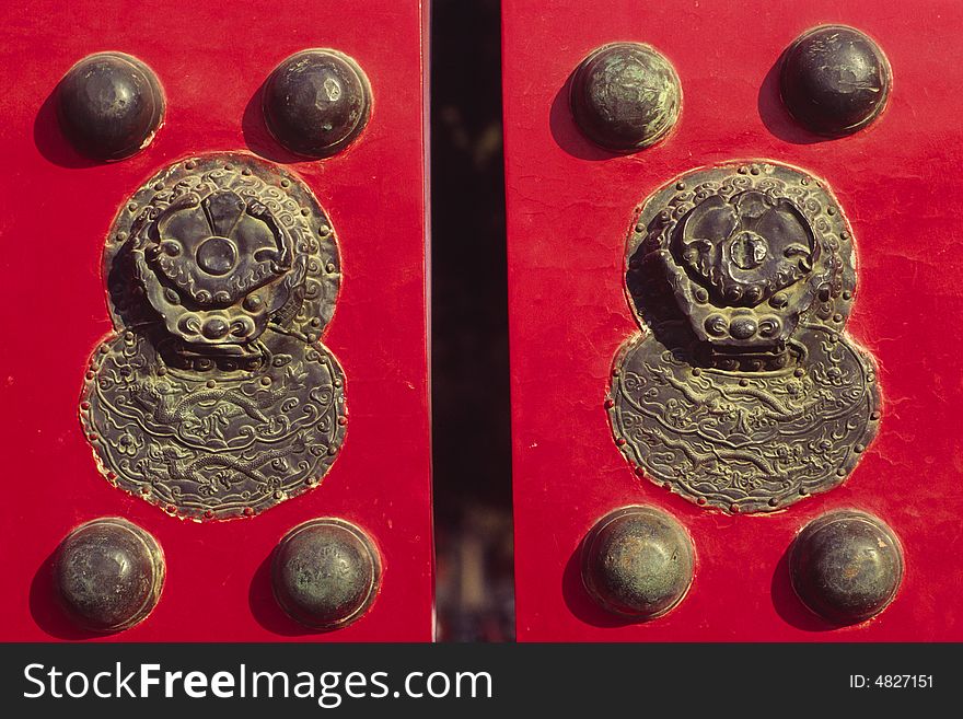 Knockers and doornails on a red door, the forbidden city, china