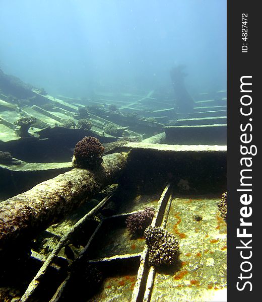 Wreck cargo strewn over the sea bed with ship hull