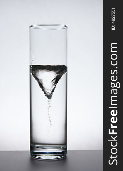 Funnel in a glass vase with water.