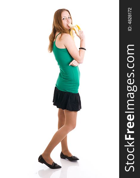 The young attractive girl with a banana isolated on a white background