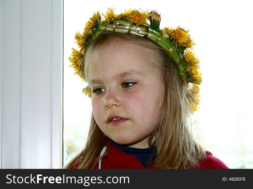 A girl with dandelion wreath