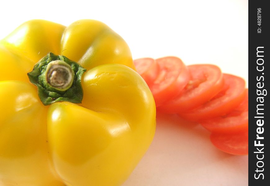 Photo of yellow capsicum and cut tomato. Photo of yellow capsicum and cut tomato