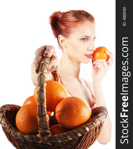 Redhead girl with basket of fresh oranges. Redhead girl with basket of fresh oranges