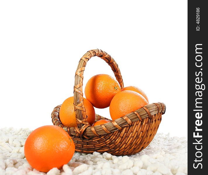 Basket with oranges isolated on white background