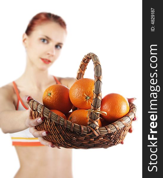 Redhead girl with basket of fresh oranges. Redhead girl with basket of fresh oranges