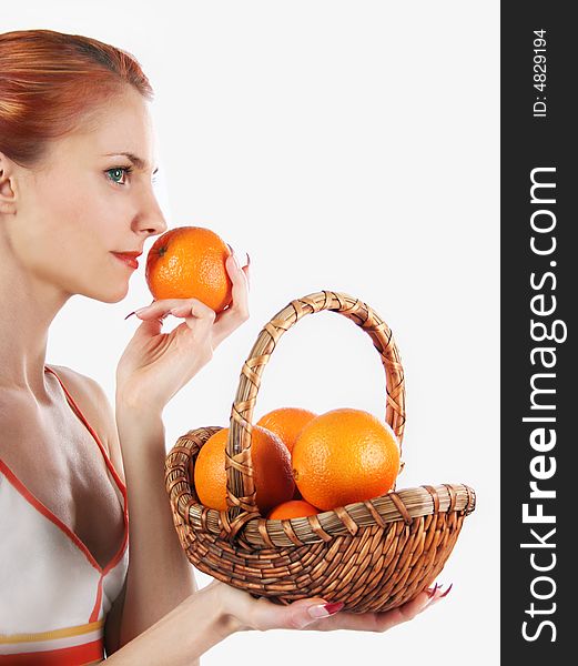 Redhead girl with basket of fresh oranges. Redhead girl with basket of fresh oranges