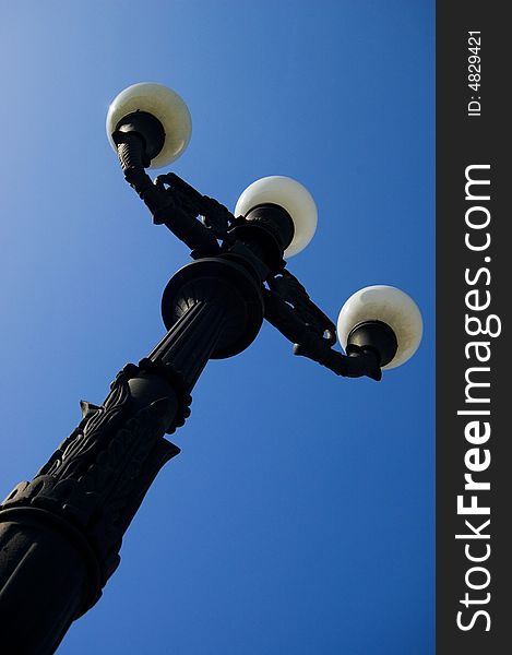 Street lamp against the backdrop of a blue sky