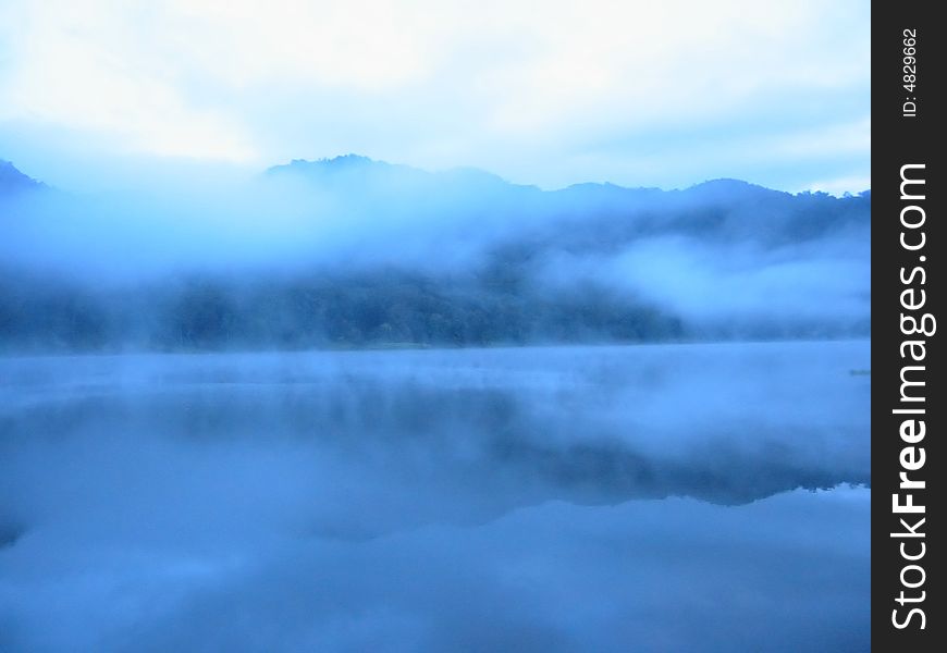 The morning haze fly smoothly on top of the lake. The morning haze fly smoothly on top of the lake