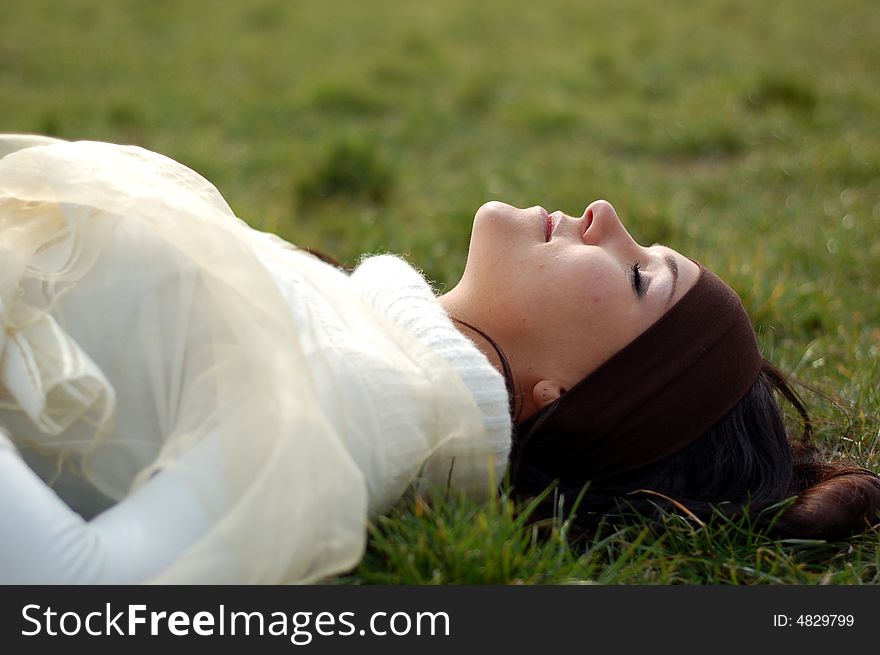 Woman Relaxing On Grass