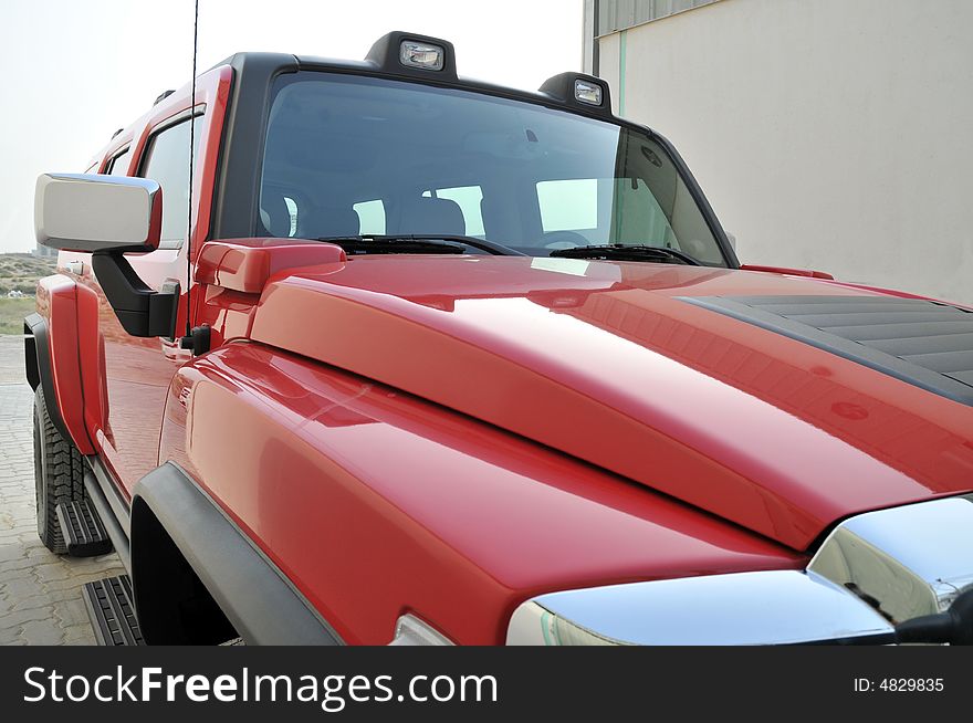 A Red Hummer H2 side view. A Red Hummer H2 side view